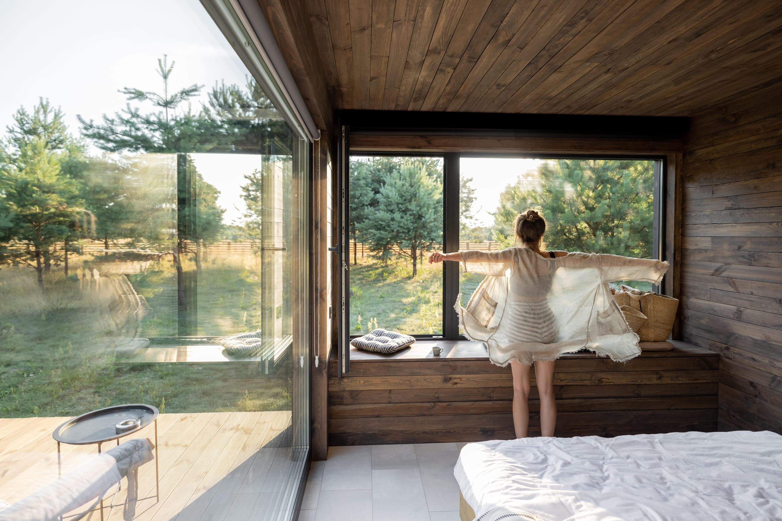 woman-wakes-up-at-country-house-in-nature-2021-09-04-12-16-08-utc-min.jpg
